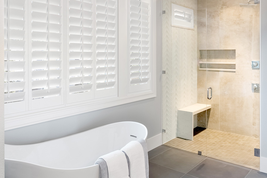 White large Polywood shutters in a modern bathroom.