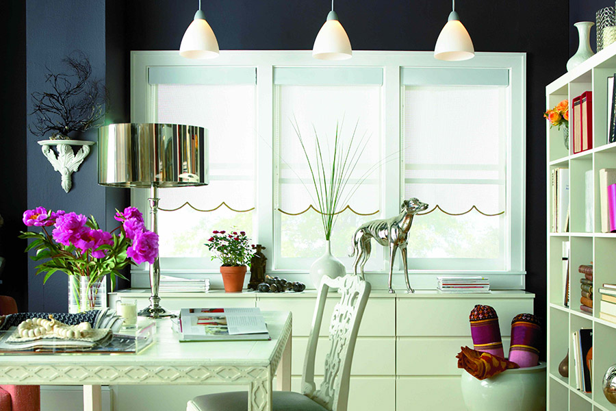 White roller shades with scalloped edge in a colorful dining room.