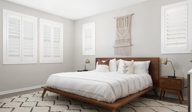 Open shutter louvers will help any San Jose room feel larger. Plantation shutters in a model home bedroom.