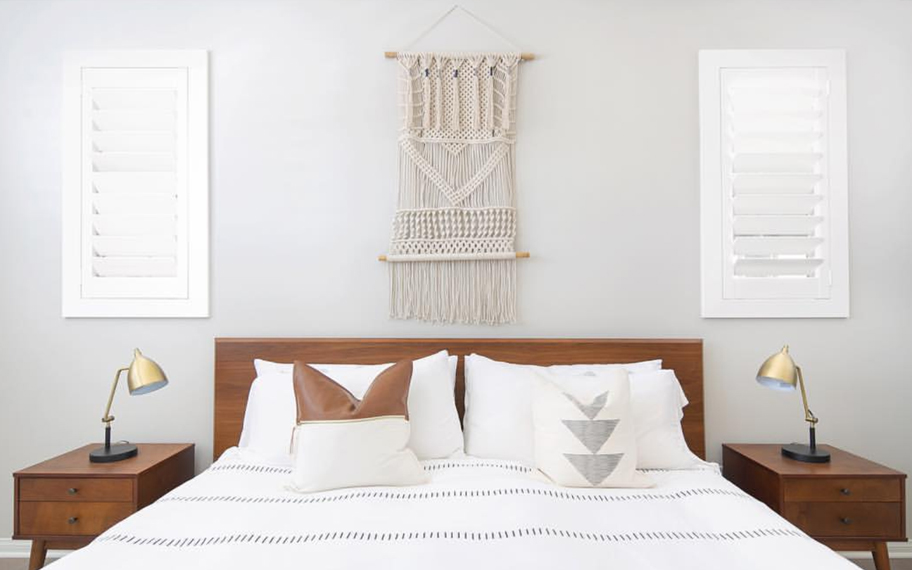 Custom-fitted louvered shutters provide excellent nighttime privacy in San Jose. Photo Credit: Audrey Crisp Louvered shutters in a bedroom.