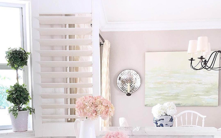 Polywood Plantation shutters are water-resistant and decorative for your kitchen space. Photo Credit: Follow The Light Home White Polywood shutters above a kitchen sink.