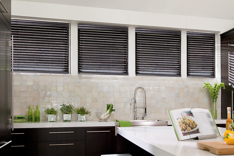 Choose custom Polywood faux wood blinds for your kitchen in San Jose. Special shaped faux wood blinds in several windows above a sink.