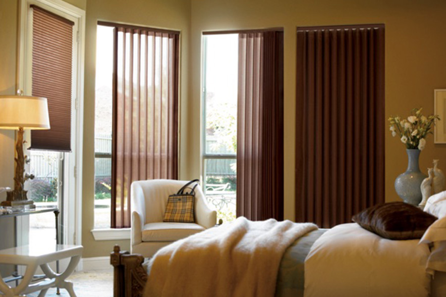 Choose durable and high-quality fabric or vinyl vertical blinds in San Jose. Maroon fabric vertical blinds inside a bedroom