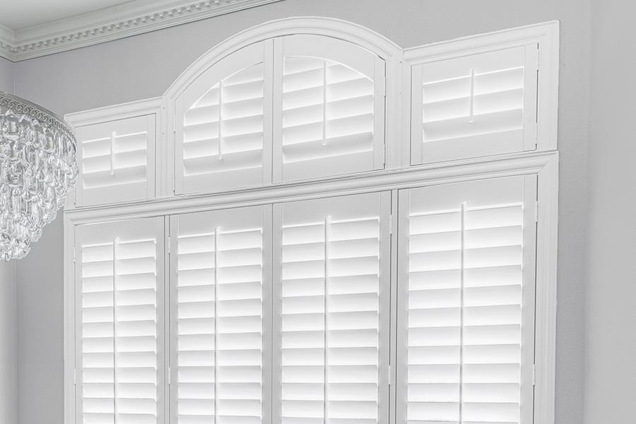 Customize your Palladian windows with white Polywood shutters in San Jose. White Polywood Palladian windows in a dining room.