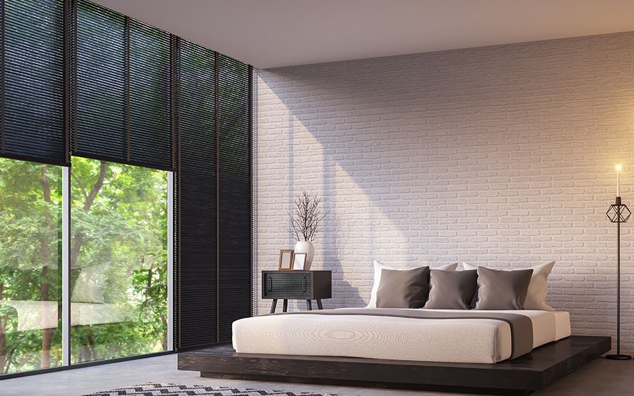 Get sleek lines when you choose roller shades vs. cellular shades in San Jose. roller shade in a modern bedroom